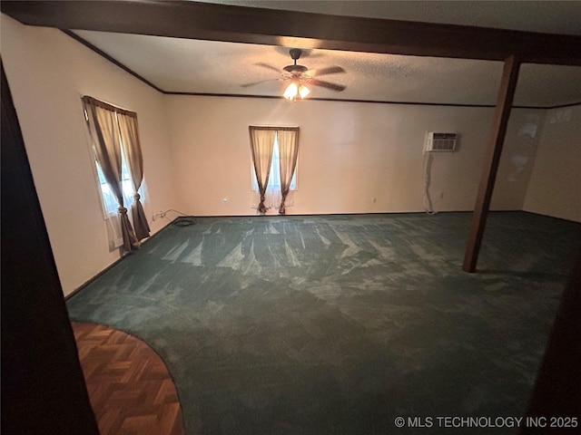 1315 W 5th St, Okmulgee, OK 74447 - empty room featuring dark carpet, a ceiling fan, and a wall mounted air conditioner