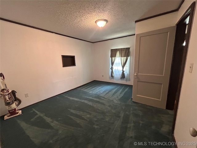 1315 W 5th St, Okmulgee, OK 74447 - unfurnished bedroom featuring dark colored carpet and a textured ceiling