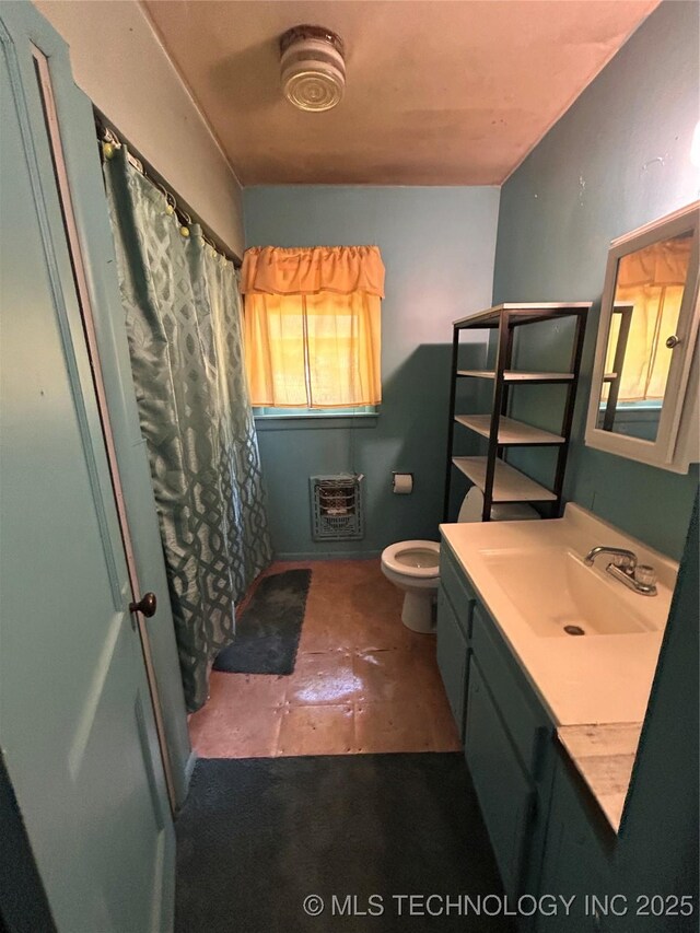 1315 W 5th St, Okmulgee, OK 74447 - bathroom featuring heating unit, vanity, and curtained shower