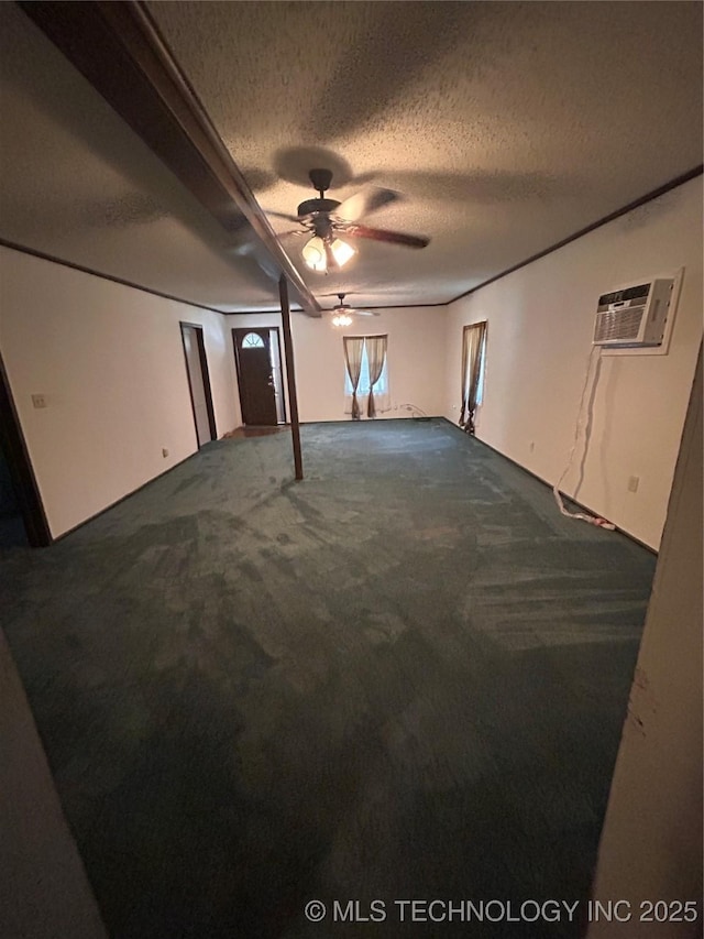 1315 W 5th St, Okmulgee, OK 74447 - unfurnished living room with carpet flooring, a ceiling fan, a textured ceiling, and a wall mounted AC