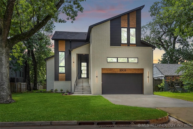 3008 S Boston Ct, Tulsa, OK 74114 - contemporary home with a garage, driveway, and brick siding