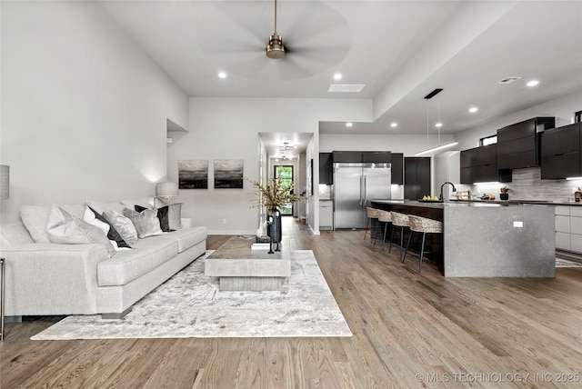 3008 S Boston Ct, Tulsa, OK 74114 - living room featuring a ceiling fan, light wood-type flooring, and recessed lighting