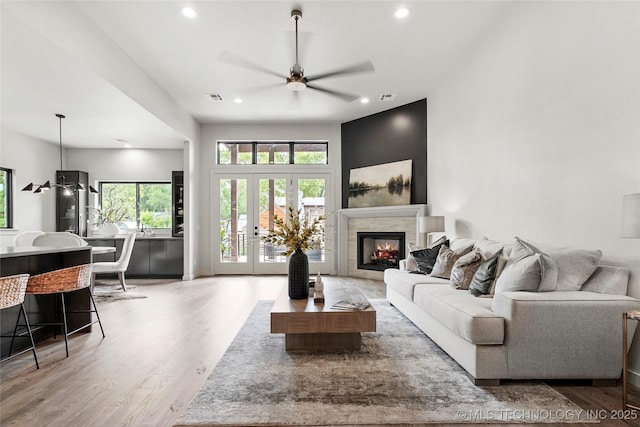 3008 S Boston Ct, Tulsa, OK 74114 - living area with a ceiling fan, light wood finished floors, recessed lighting, plenty of natural light, and a tiled fireplace
