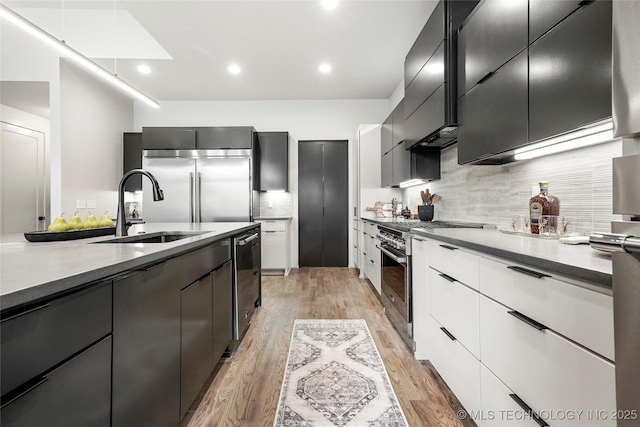 3008 S Boston Ct, Tulsa, OK 74114 - kitchen with high end appliances, light wood-type flooring, modern cabinets, and recessed lighting