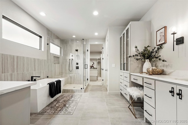 3008 S Boston Ct, Tulsa, OK 74114 - bathroom featuring a shower stall, a freestanding bath, vanity, recessed lighting, and tile patterned floors