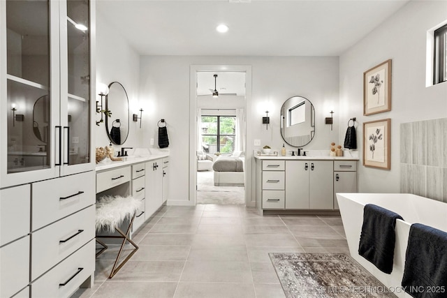 3008 S Boston Ct, Tulsa, OK 74114 - ensuite bathroom with a ceiling fan, two vanities, a soaking tub, tile patterned flooring, and recessed lighting