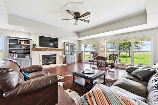 23535 E 720th Rd, Wagoner, OK 74467 - living area with a tray ceiling, a ceiling fan, ornamental molding, wood finished floors, and a fireplace