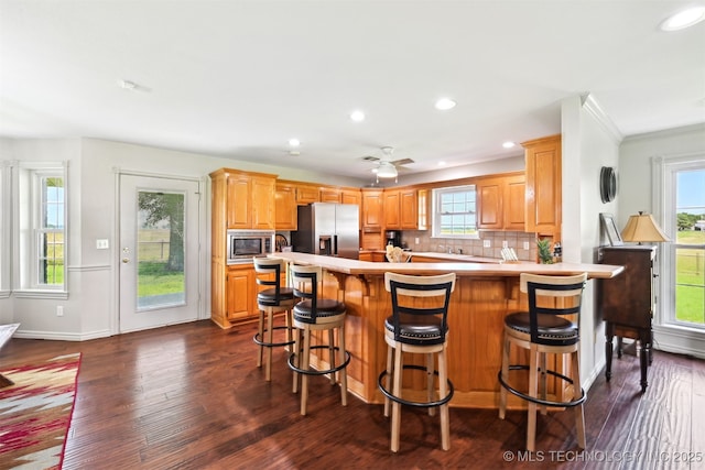 23535 E 720th Rd, Wagoner, OK 74467 - kitchen featuring appliances with stainless steel finishes, dark wood-type flooring, light countertops, a peninsula, and recessed lighting