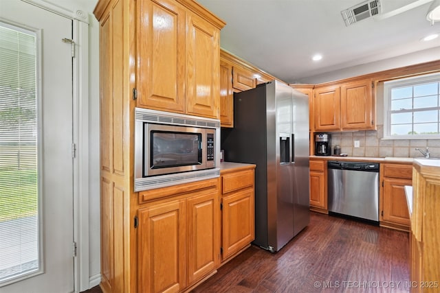 23535 E 720th Rd, Wagoner, OK 74467 - kitchen featuring appliances with stainless steel finishes, light countertops, decorative backsplash, dark wood-style floors, and recessed lighting