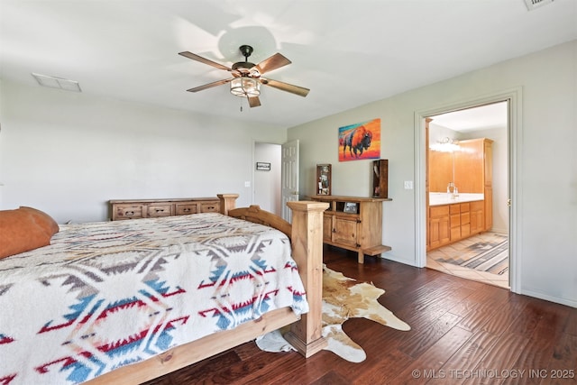 23535 E 720th Rd, Wagoner, OK 74467 - bedroom with wood finished floors, ceiling fan, and ensuite bathroom