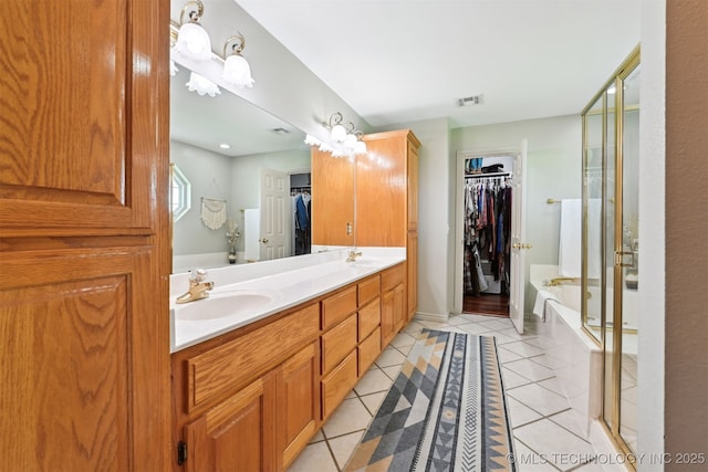 23535 E 720th Rd, Wagoner, OK 74467 - full bathroom with a spacious closet, double vanity, a garden tub, and tile patterned flooring