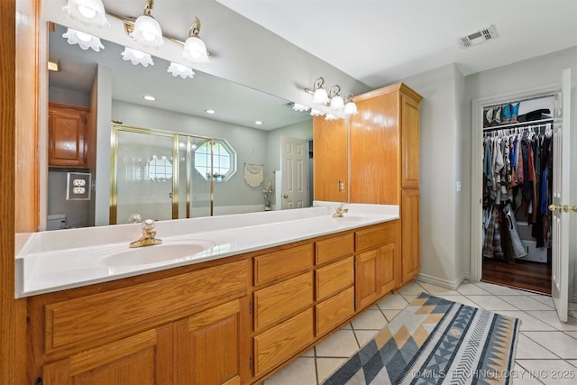 23535 E 720th Rd, Wagoner, OK 74467 - bathroom featuring double vanity, tile patterned flooring, a stall shower, and a spacious closet
