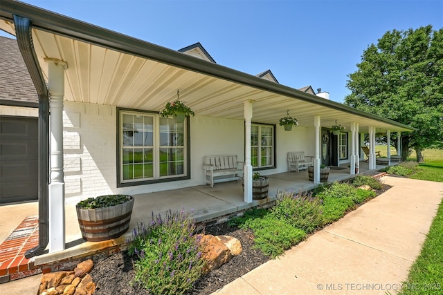23535 E 720th Rd, Wagoner, OK 74467 - doorway to property featuring covered porch and brick siding