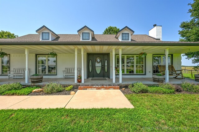 23535 E 720th Rd, Wagoner, OK 74467 - farmhouse-style home with a porch, a shingled roof, a chimney, a front lawn, and stucco siding