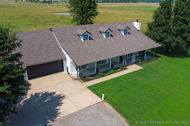 23535 E 720th Rd, Wagoner, OK 74467 - view of front of house with a porch, a front yard, concrete driveway, a garage, and a chimney