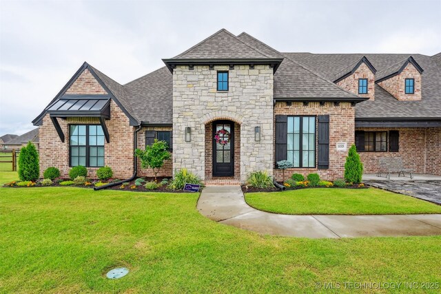 11325 S 212th E Ave, Broken Arrow, OK 74014 - french country inspired facade with roof with shingles, a front yard, stone siding, and brick siding