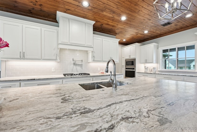 11325 S 212th E Ave, Broken Arrow, OK 74014 - kitchen with wooden ceiling, recessed lighting, appliances with stainless steel finishes, decorative backsplash, and white cabinetry
