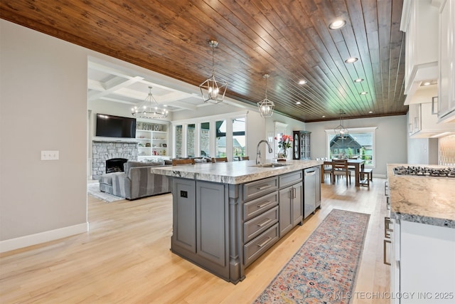 11325 S 212th E Ave, Broken Arrow, OK 74014 - kitchen with gray cabinets, a fireplace, white cabinets, light wood-type flooring, and stainless steel appliances