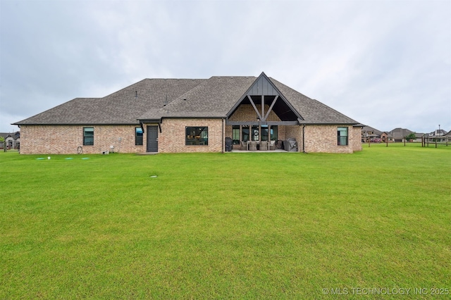11325 S 212th E Ave, Broken Arrow, OK 74014 - rear view of house with a lawn, roof with shingles, and brick siding