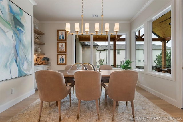 6026 E 119th Pl, Tulsa, OK 74137 - dining area featuring a chandelier, light wood finished floors, and crown molding