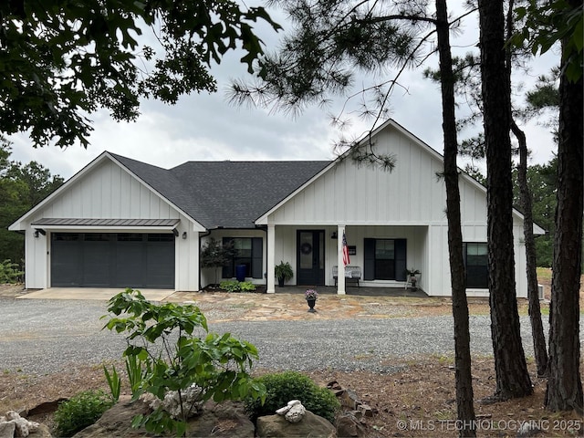 13425 SW 1025th Ave, Tuskahoma, OK 74571 - modern farmhouse style home with covered porch, gravel driveway, roof with shingles, board and batten siding, and a garage