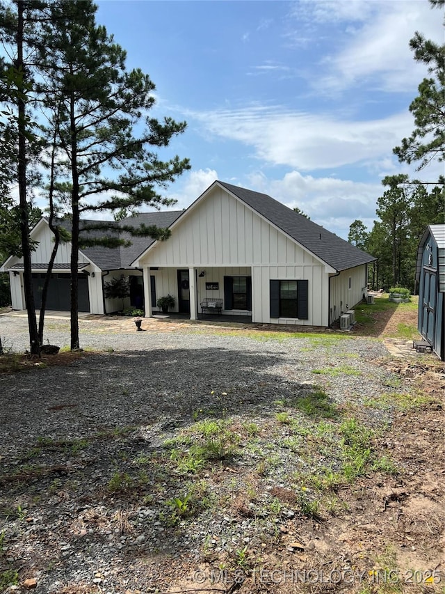 13425 SW 1025th Ave, Tuskahoma, OK 74571 - view of side of home featuring board and batten siding, roof with shingles, and an outbuilding