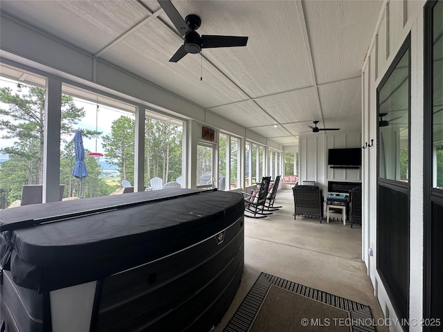 13425 SW 1025th Ave, Tuskahoma, OK 74571 - sunroom with ceiling fan, a jacuzzi, and concrete floors
