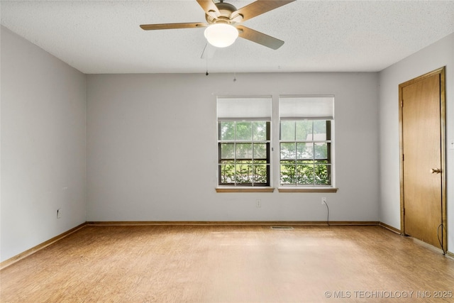 911 N Fir St, Jenks, OK 74037 - spare room featuring a ceiling fan and a textured ceiling