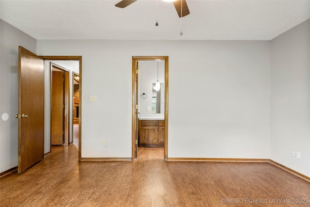 911 N Fir St, Jenks, OK 74037 - spare room featuring wood finished floors and a ceiling fan
