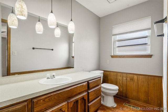 911 N Fir St, Jenks, OK 74037 - bathroom with vanity, a wainscoted wall, and wood finished floors