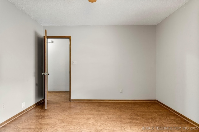 911 N Fir St, Jenks, OK 74037 - empty room with light wood-style flooring and a textured ceiling