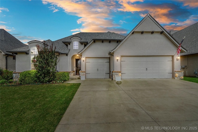 12913 S Ash St, Jenks, OK 74037 - french country inspired facade featuring stucco siding, an attached garage, driveway, and a front yard