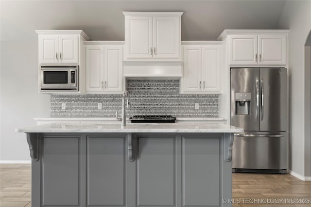 12913 S Ash St, Jenks, OK 74037 - kitchen featuring stainless steel appliances, light wood finished floors, and white cabinetry