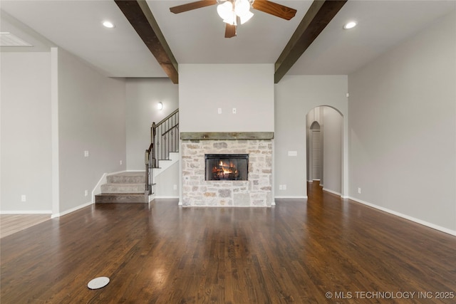 12913 S Ash St, Jenks, OK 74037 - unfurnished living room with ceiling fan, beam ceiling, arched walkways, stairway, and wood finished floors