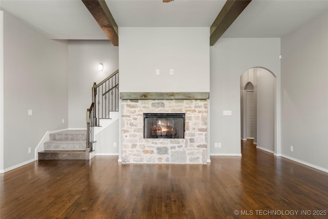 12913 S Ash St, Jenks, OK 74037 - unfurnished living room with beam ceiling, wood finished floors, arched walkways, stairs, and a fireplace