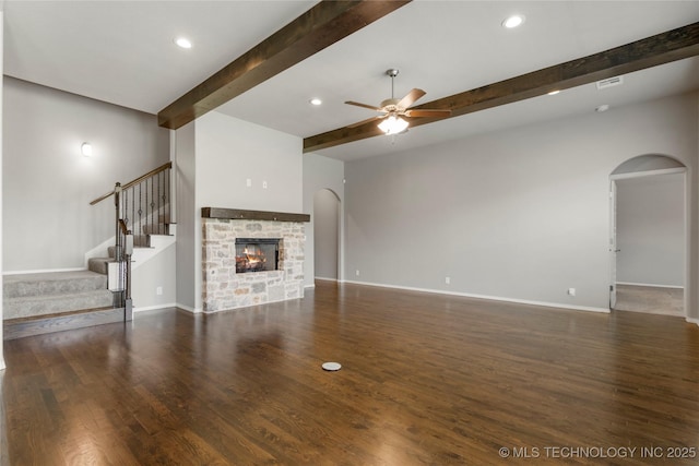 12913 S Ash St, Jenks, OK 74037 - unfurnished living room with ceiling fan, beamed ceiling, arched walkways, stairway, and wood finished floors