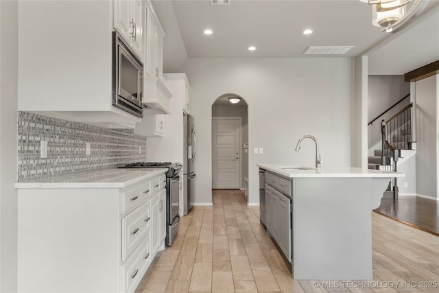 12913 S Ash St, Jenks, OK 74037 - kitchen with stainless steel appliances, a kitchen island with sink, backsplash, light countertops, and recessed lighting