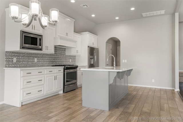 12913 S Ash St, Jenks, OK 74037 - kitchen with appliances with stainless steel finishes, light wood finished floors, light countertops, backsplash, and recessed lighting