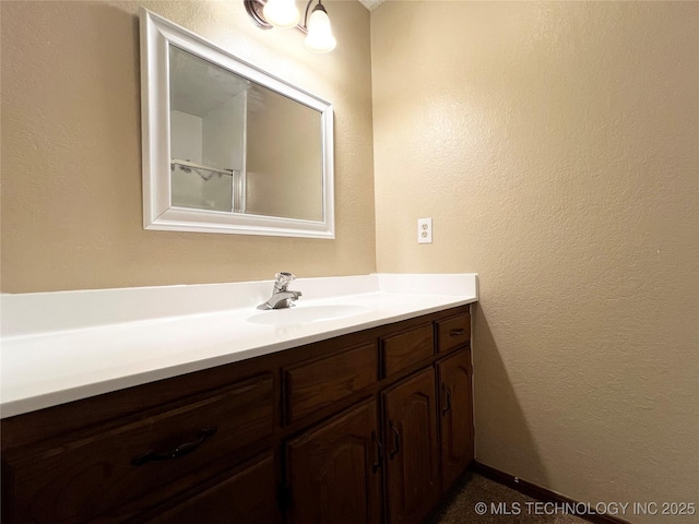 619 W 4th St, Skiatook, OK 74070 - bathroom featuring vanity and a textured wall