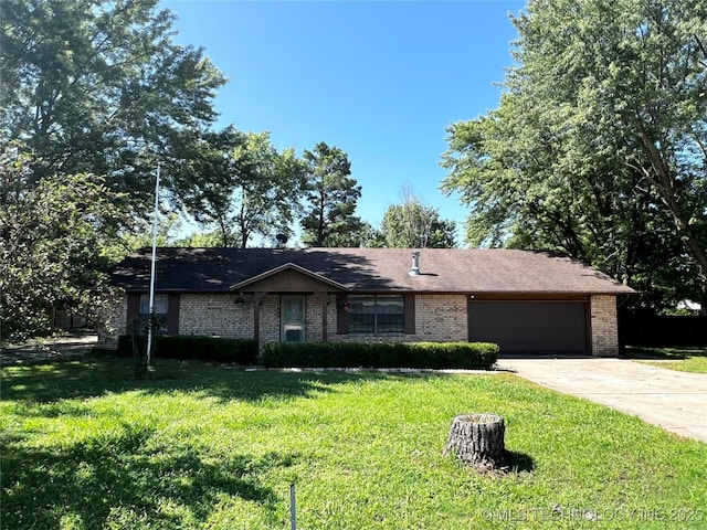 619 W 4th St, Skiatook, OK 74070 - single story home with a garage, concrete driveway, a front lawn, and brick siding
