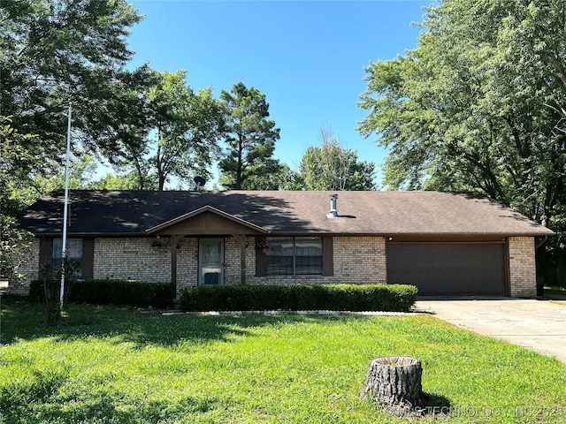619 W 4th St, Skiatook, OK 74070 - ranch-style home featuring brick siding, a garage, a front lawn, and concrete driveway