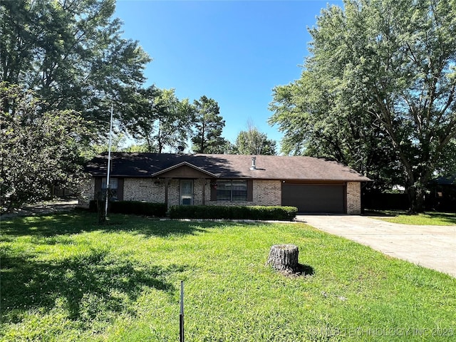 619 W 4th St, Skiatook, OK 74070 - ranch-style house featuring a garage, concrete driveway, a front yard, and brick siding