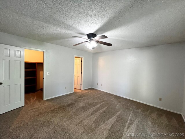 619 W 4th St, Skiatook, OK 74070 - unfurnished bedroom with carpet flooring, a spacious closet, ceiling fan, a closet, and a textured ceiling