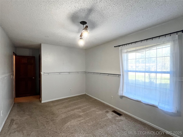 619 W 4th St, Skiatook, OK 74070 - unfurnished room featuring carpet floors and a textured ceiling