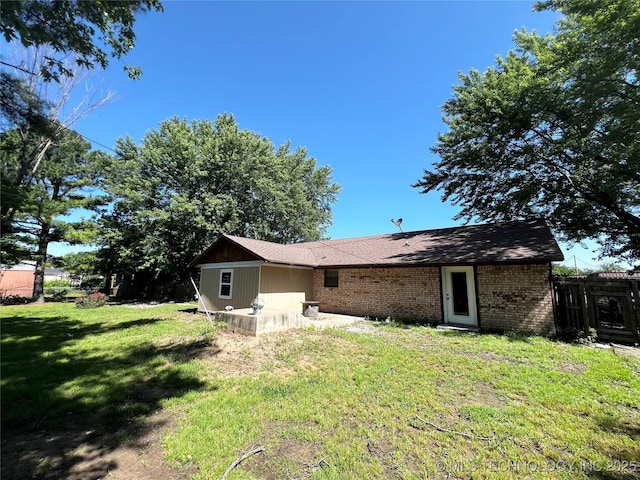 619 W 4th St, Skiatook, OK 74070 - rear view of property featuring brick siding