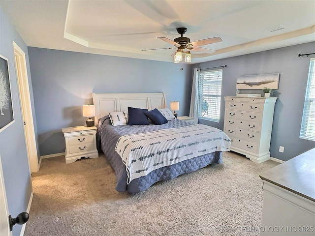14603 E 114th St, Owasso, OK 74055 - bedroom with light carpet, ceiling fan, and a tray ceiling