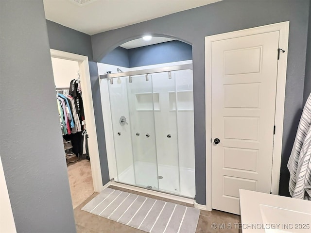 14603 E 114th St, Owasso, OK 74055 - full bath featuring a stall shower, a spacious closet, and tile patterned floors