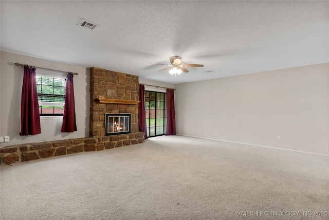 816 N Birch St, Jenks, OK 74037 - unfurnished living room with a ceiling fan, carpet flooring, a stone fireplace, and a textured ceiling