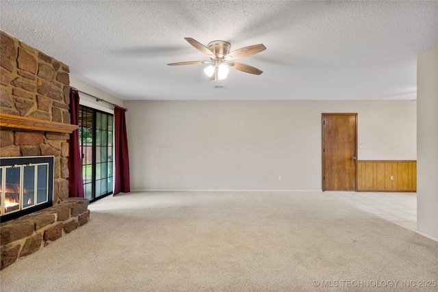 816 N Birch St, Jenks, OK 74037 - unfurnished living room featuring carpet flooring, a ceiling fan, a textured ceiling, and a stone fireplace