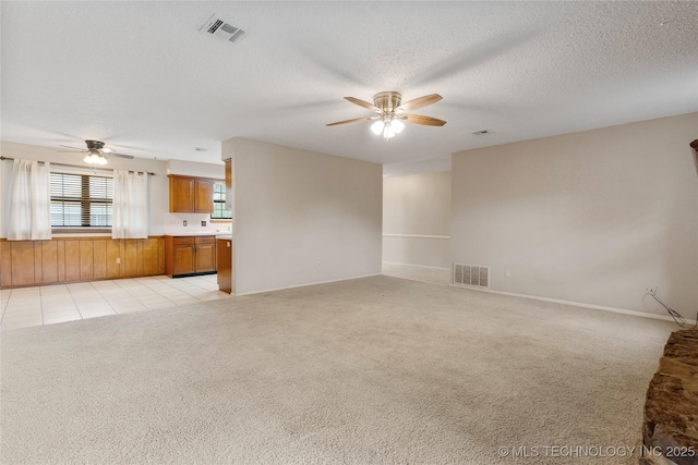 816 N Birch St, Jenks, OK 74037 - unfurnished living room featuring ceiling fan, light colored carpet, and a textured ceiling